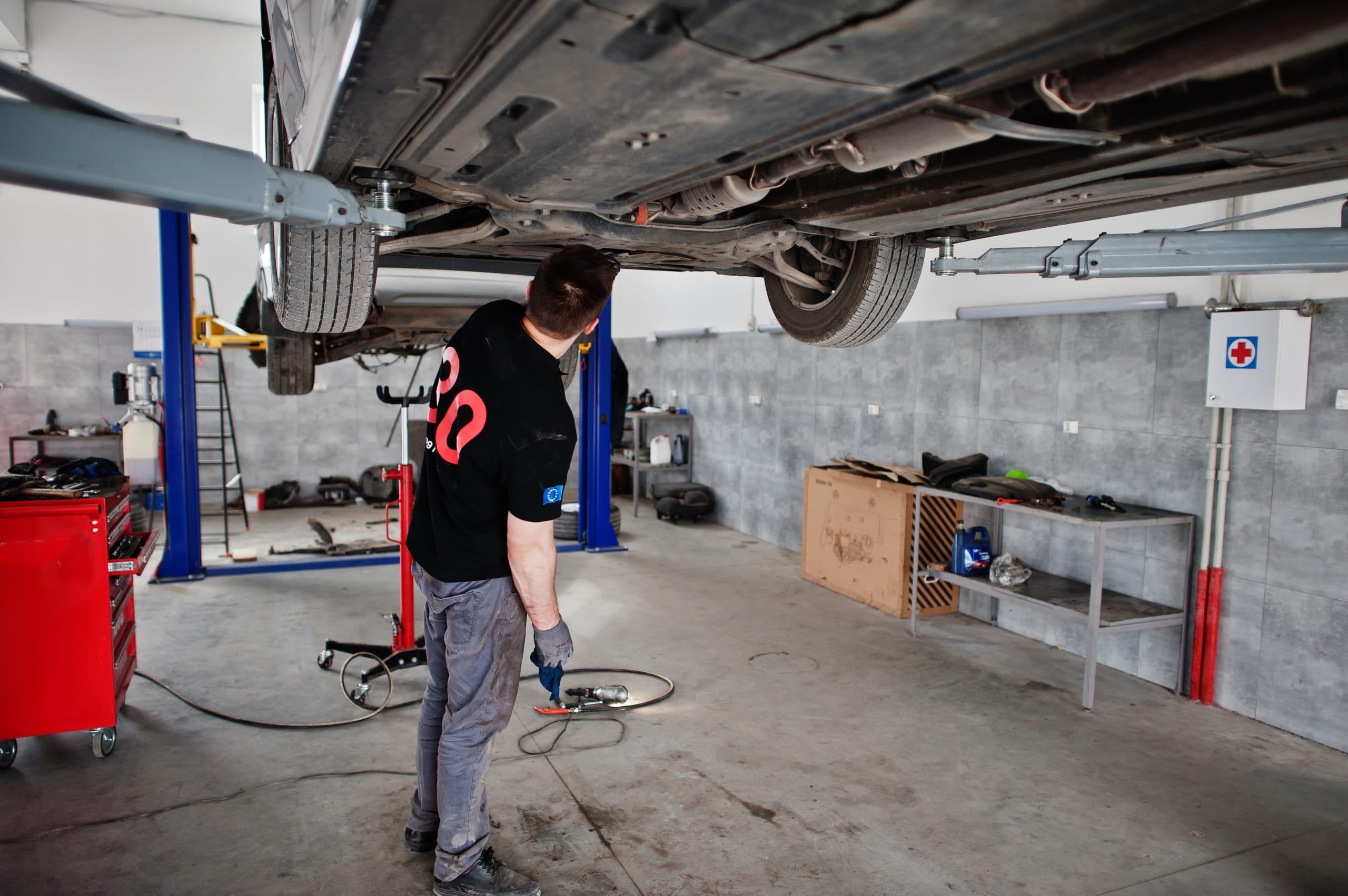 Total Car Care technician in uniform servicing a vehicle in the workshop